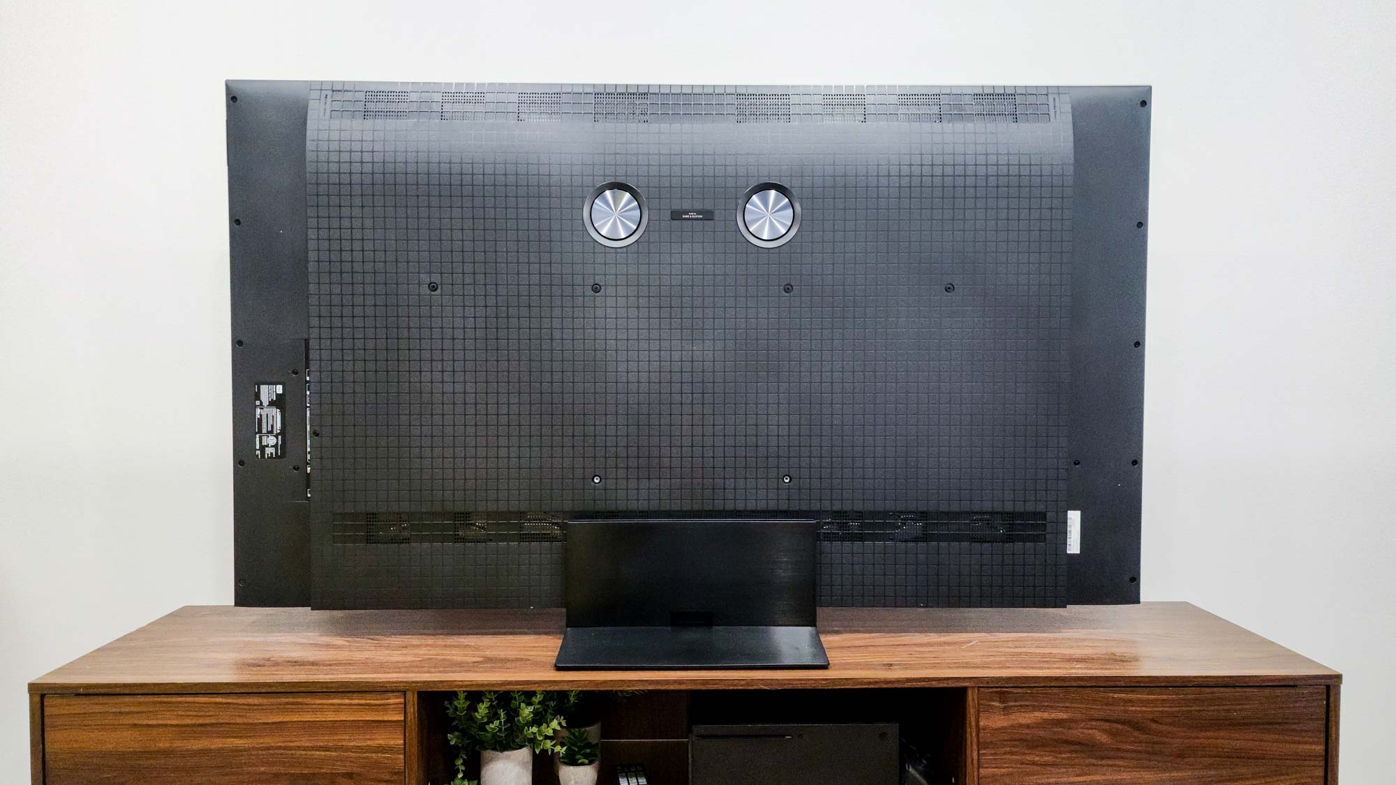 The back of a TCL QM7K QD-Mini LED TV on a side table