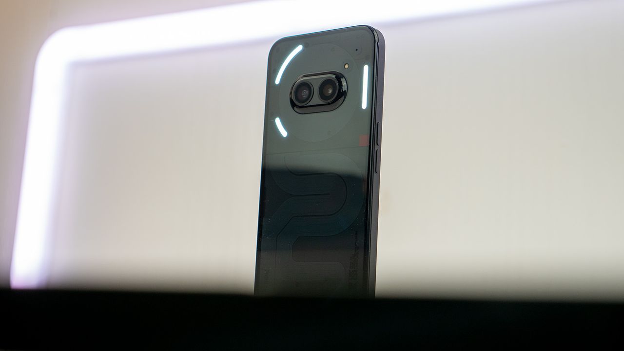 The back of the Nothing Phone (2a) with the glyph lights illuminated