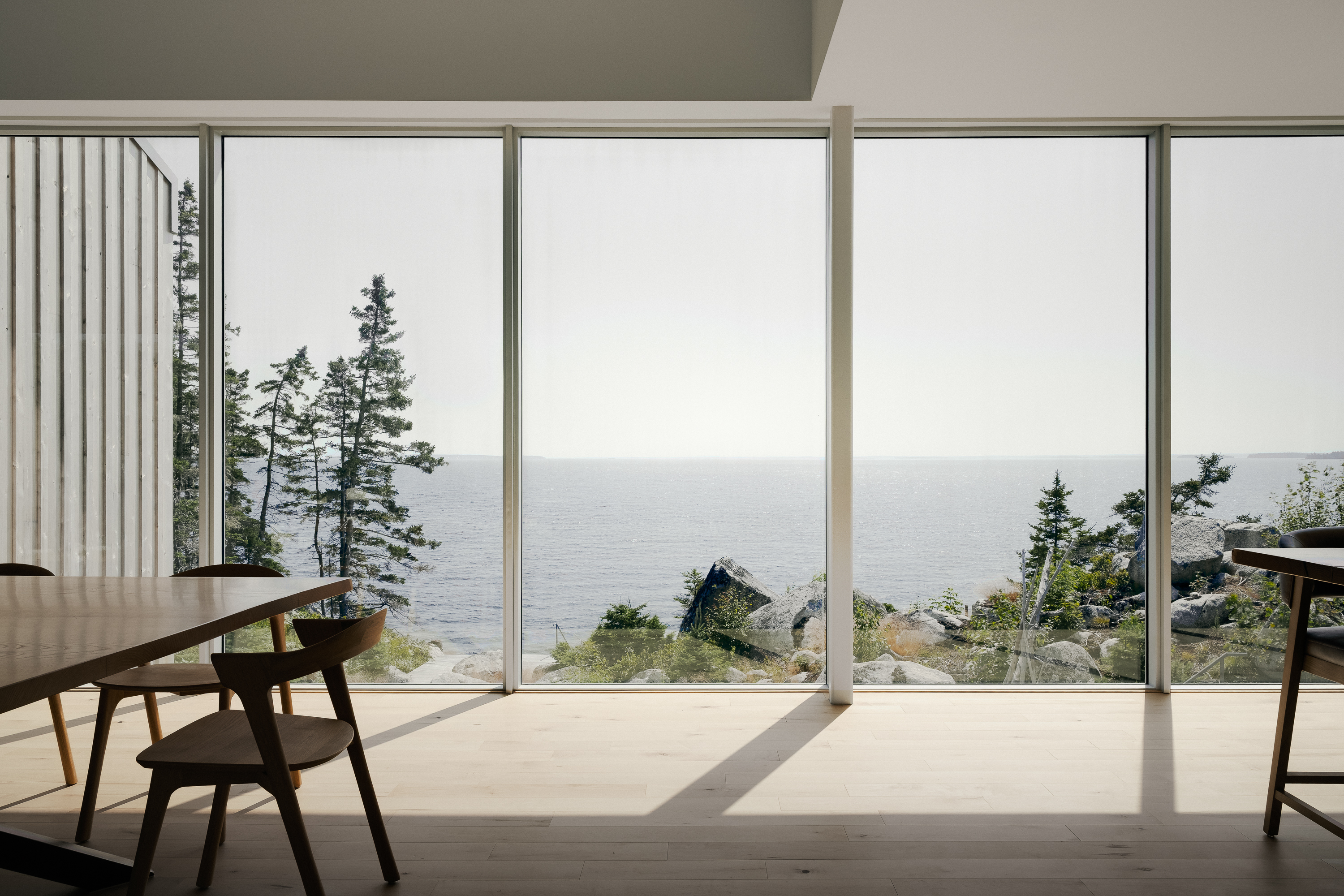 view of East River Residence, a delicate Nova Scotia house made of glazing and timber and open to rugged landscape vistas