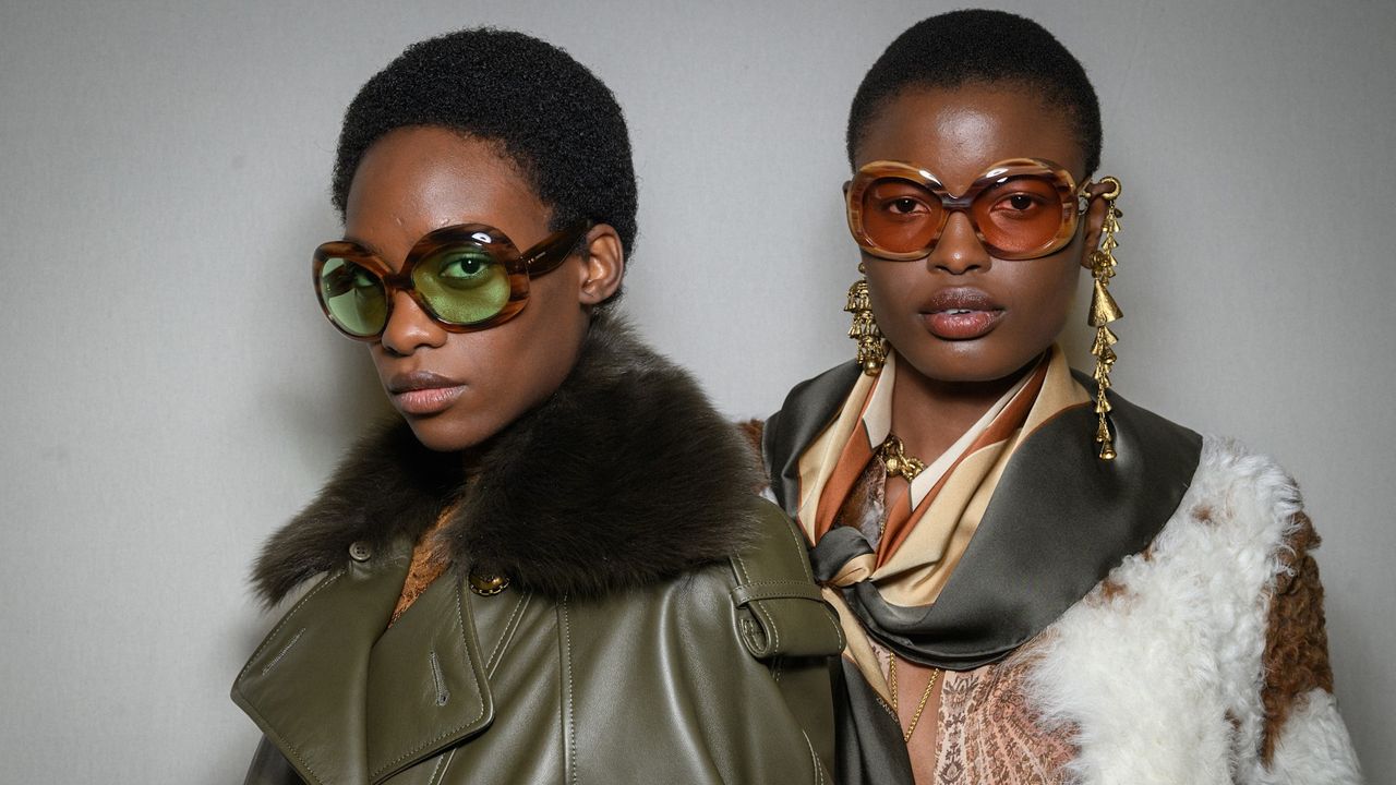 two models with dark skin tone in big sunglasses and fur jacket