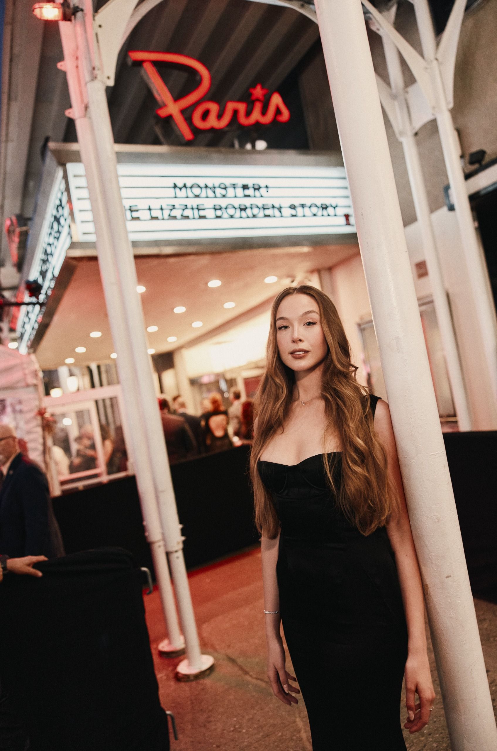 ella beatty wears a black gown as she poses outside of the paris theater in new york city for the premiere of monster the lizzie borden story