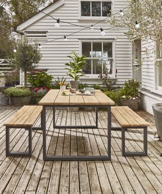 Indoor/outdoor acacia dining set on a decked patio