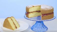 Mary Berry's Victoria sponge on a cake stand with a slice cut out and served on a plate