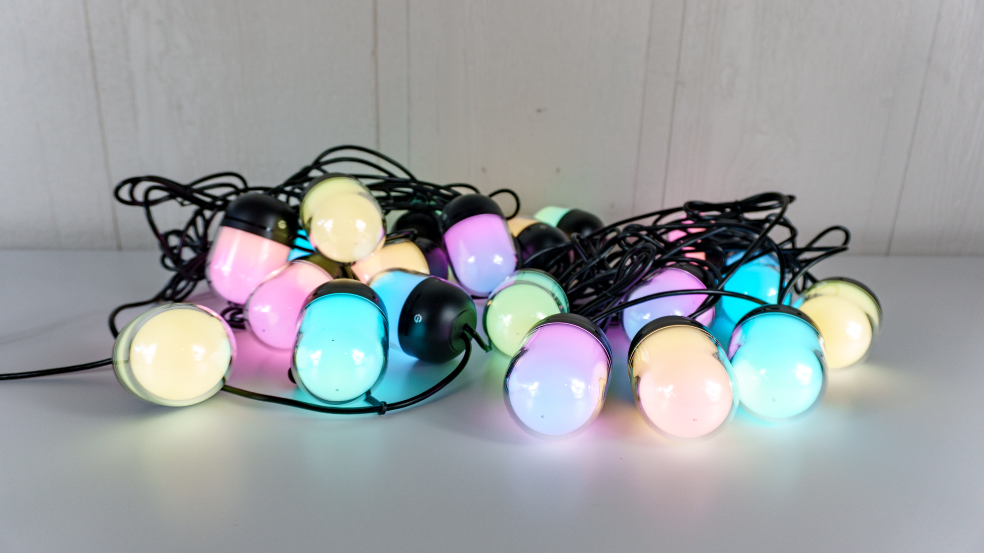 Testing Govee's Outdoor Chromatic String Lights on a table before installing them