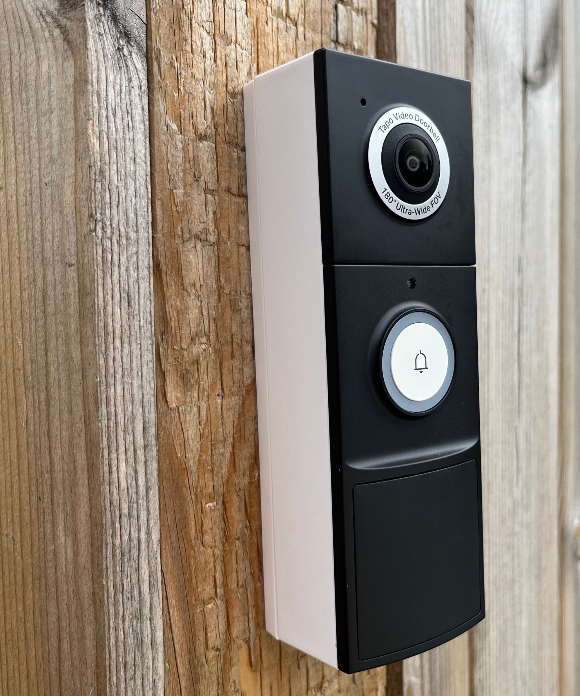 The Tapo D235 video doorbell installed to a wooden fence recording footage and audio next to our side gate.