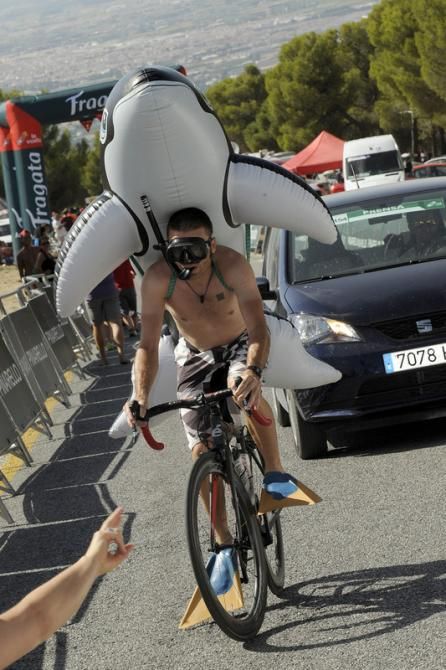 A fans decides to ride up to the finish line dresses as a shark with flippers on his feet