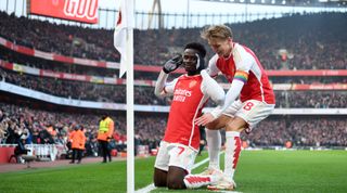 LONDON, ENGLAND - DECEMBER 02: Bukayo Saka of Arsenal celebrates with teammate Martin Odegaard after scoring the team's first goal during the Premier League match between Arsenal FC and Wolverhampton Wanderers at Emirates Stadium on December 02, 2023 in London, England. (Photo by Stuart MacFarlane/Arsenal FC via Getty Images)