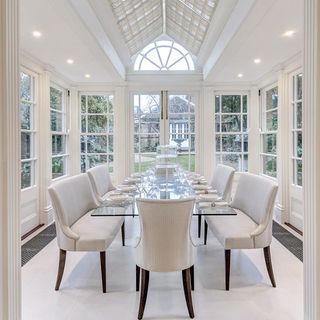 dining room with white dining table and chair on white flooring