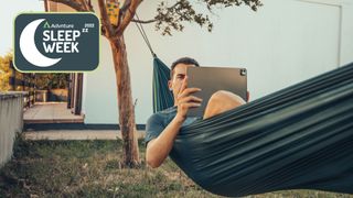 Man in hammock working on laptop