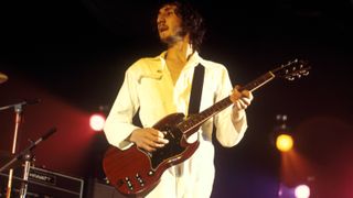 English guitarist Pete Townshend, wearing his trademark white boiler suit, performs live on stage playing a Gibson SG Special guitar, with rock group The Who during the European leg of the band's Tommy Tour at a venue in England in October 1970.