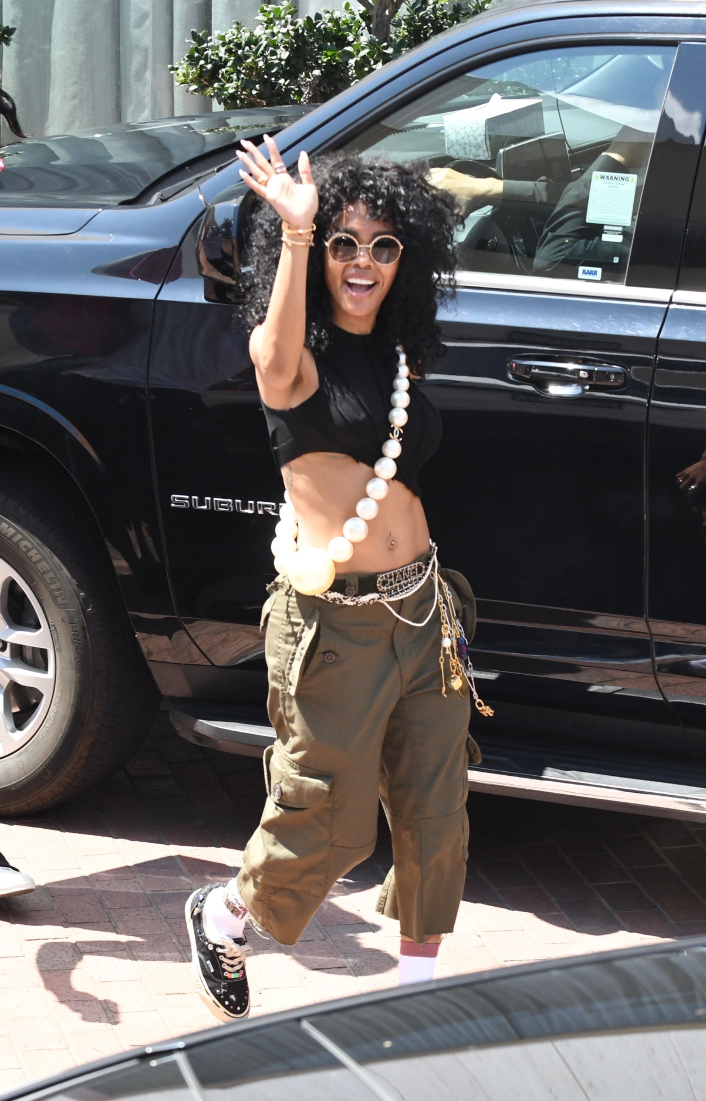 Teyana Taylor styled the Vans summer sneaker trend with a Chanel bag and capri pants