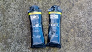 A pair of SIS Beta Fuel Energy Gels on the floor