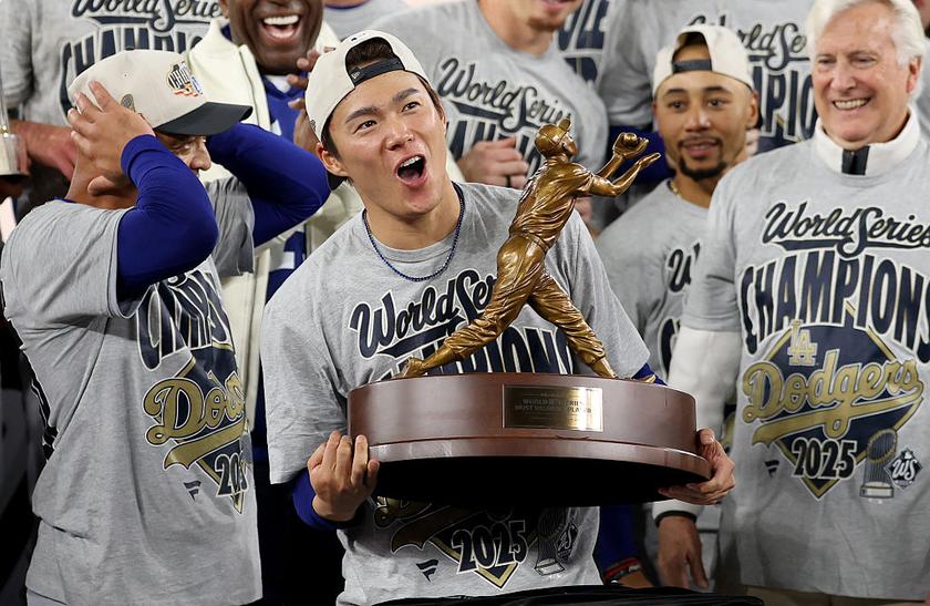 TORONTO, ONTARIO - NOVEMBER 02: Yoshinobu Yamamoto #18 of the Los Angeles Dodgers raises the Willie Mays World Series Most Valuable Player Award after defeating the Toronto Blue Jays 5-4 in game seven of the 2025 World Series at Rogers Center on November 02, 2025 in Toronto, Ontario. (Photo by Emilee Chinn/Getty Images)