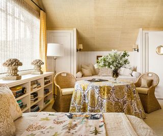 bedroom with textured wallcovering and skirted table and paneled wall