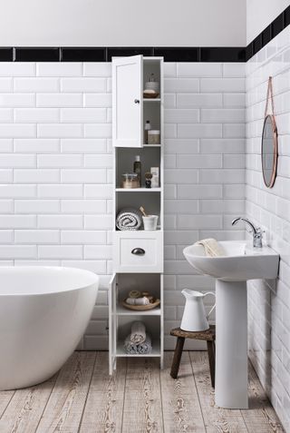 white bathroom with metro tiles and a white tall boy