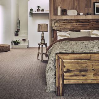 neutral bedroom with a bold timber bed and lots of coordinating timber furniture, panelling and accessories