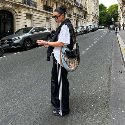 An influencer wearing adidas track pants