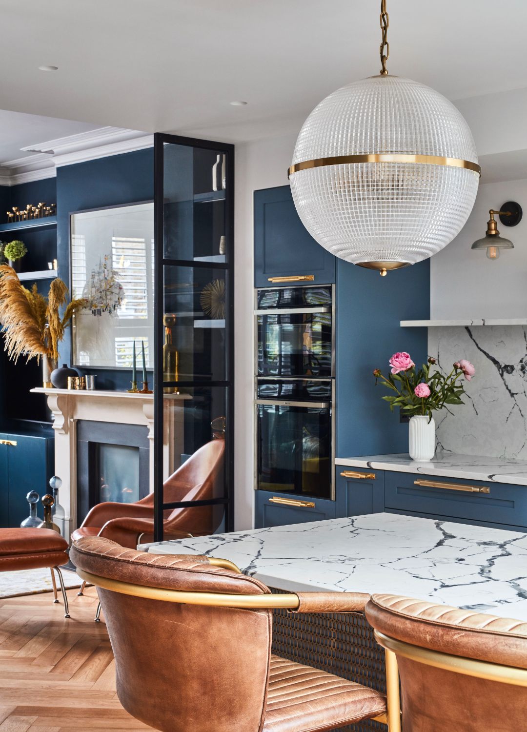 picture of blue kitchen with matching marble and gold fixtures and accents