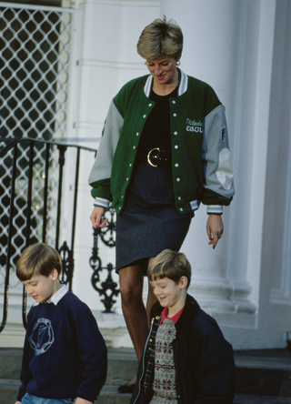 Diana, Princess of Wales (1961 - 1997) wearing a Philadelphia Eagles jacket to drop off her son Prince Harry at Wetherby School in London, January 1991. Prince William (left) is leaving with her, accompanied by a friend