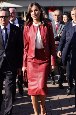 Queen Letizia wearing a red leather jacket and skirt