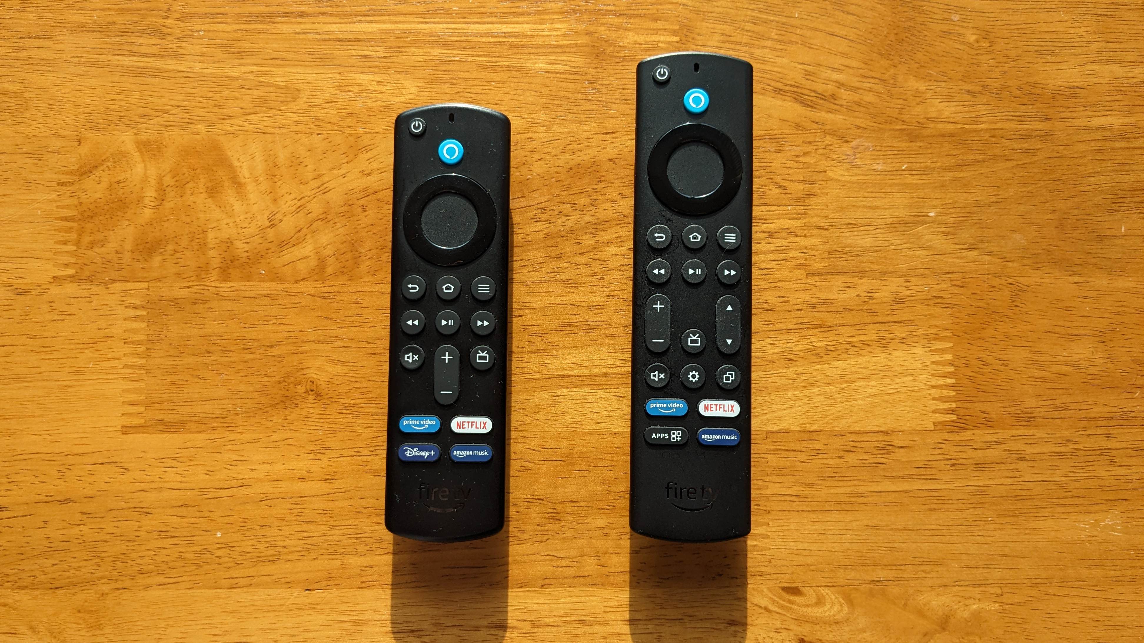 The Amazon Fire TV Stick 4K and Amazon Fire TV Stick 4K Max remotes side by side on a wooden table