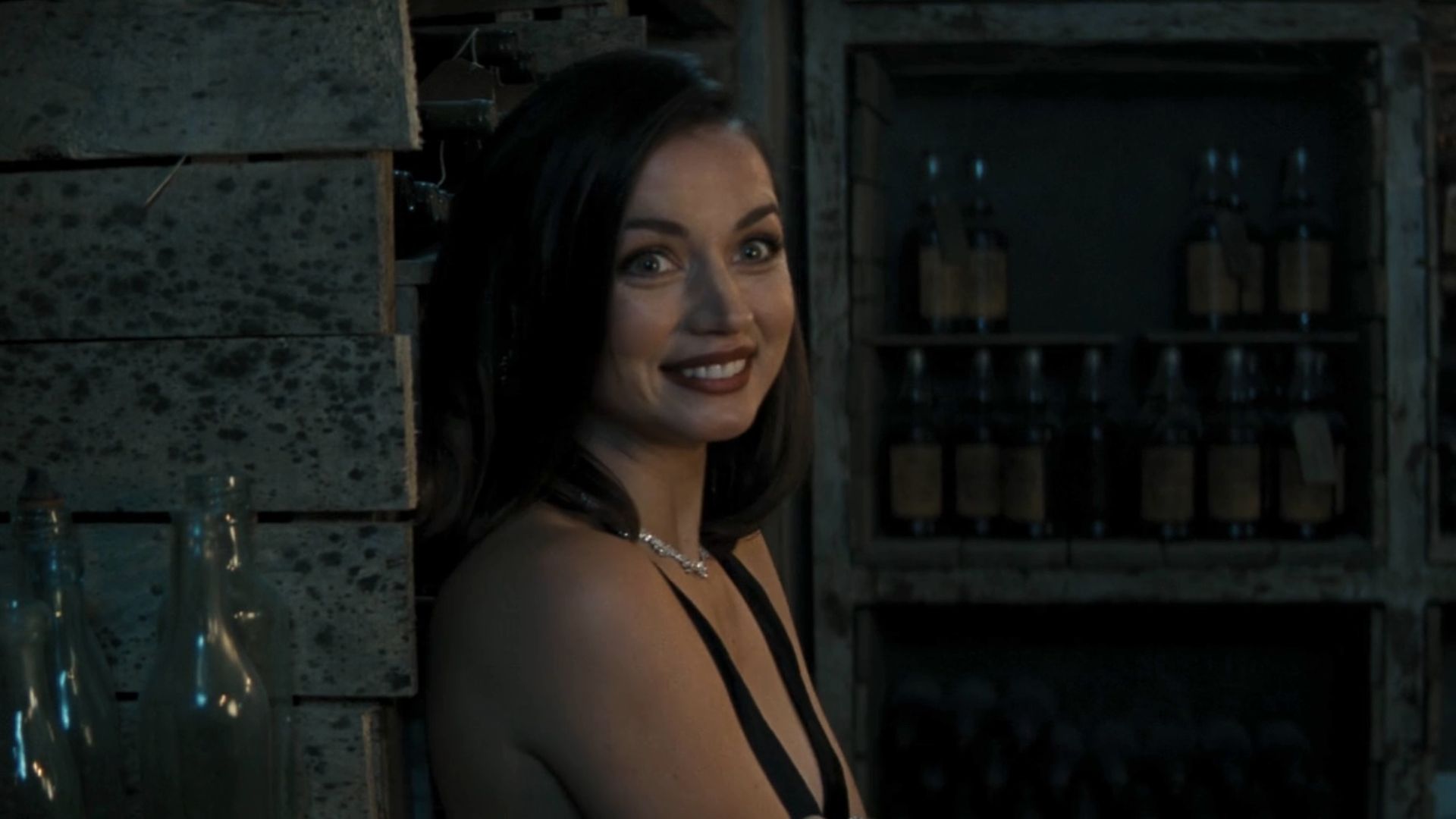 Ana de Armas smiling in a black dress in No Time to Die