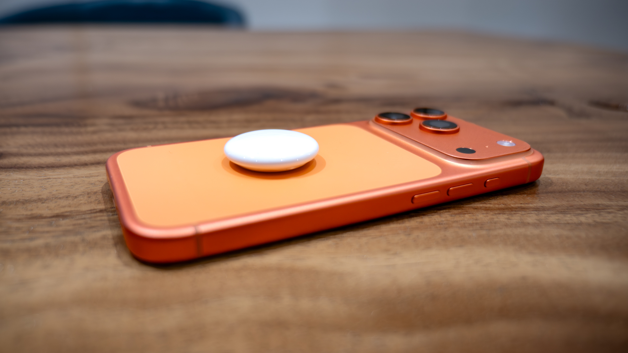 Apple AirTag 2 on top of iPhone 17 Pro.