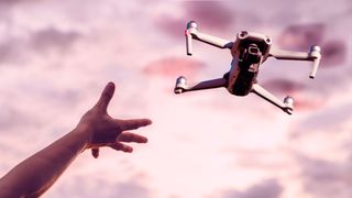 Hand reaches out for one of the best drones