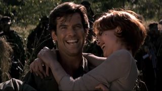 Pierce Brosnan carries Isabella Scorupco as they laugh in Goldeneye.