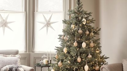 Christmas tree with decorations in a neutral living room