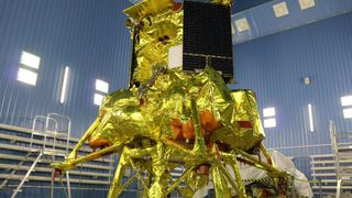 a moon lander wrapped in gold foil