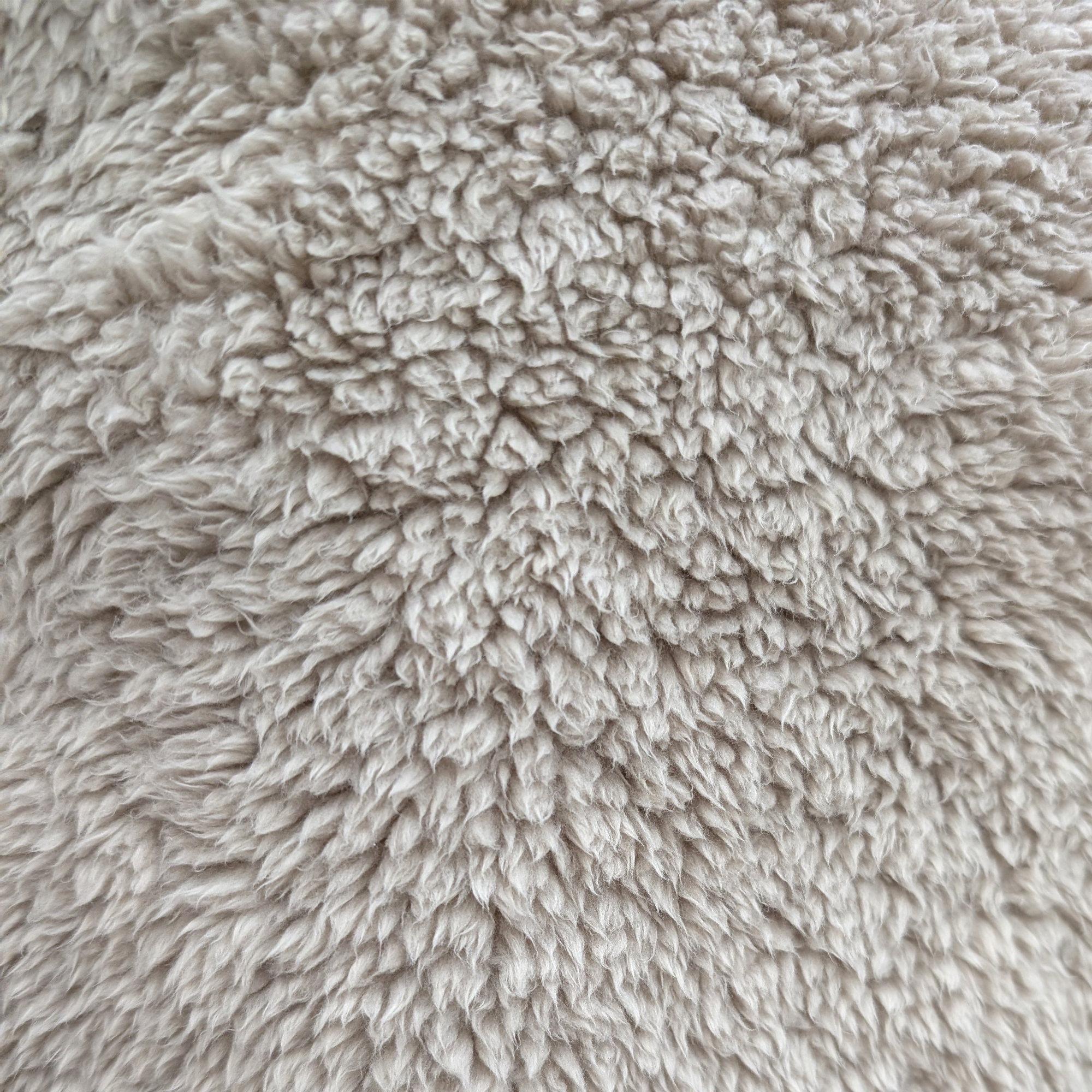 Dunelm Teddy Bear cuddle cushion fabric close up showing texture
