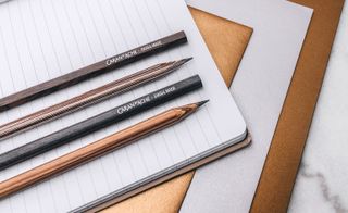 Pencils laid out on writing paper