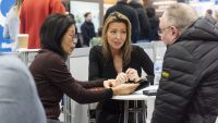 A couple talking to an expert at the Advice Centre at the Homebuilding & Renovating Show