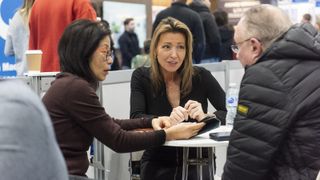 A couple talking to an expert at the Advice Centre at the Homebuilding & Renovating Show