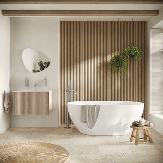 Bathroom with neutral tones and a modern wood panelled wall behind the freestanding bath
