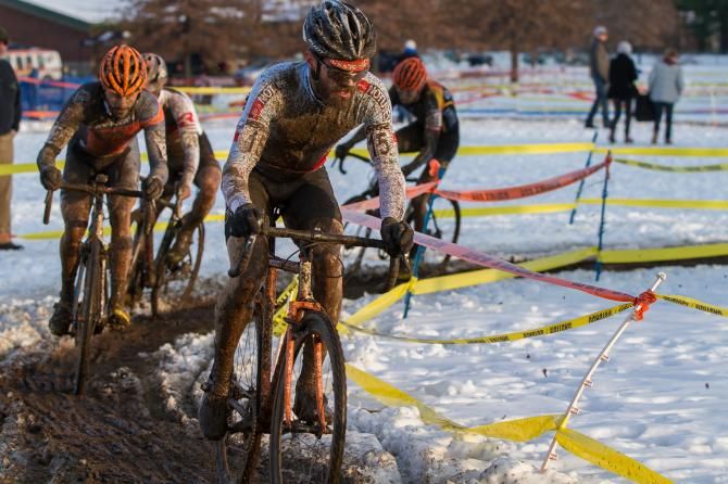 Timmerman, his leader's jersey unrecognizable in the mud, leads through a tricky corner