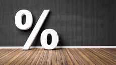 Percent symbol leaning against wall