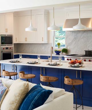 royal blue kitchen with large kitchen island and white wall units