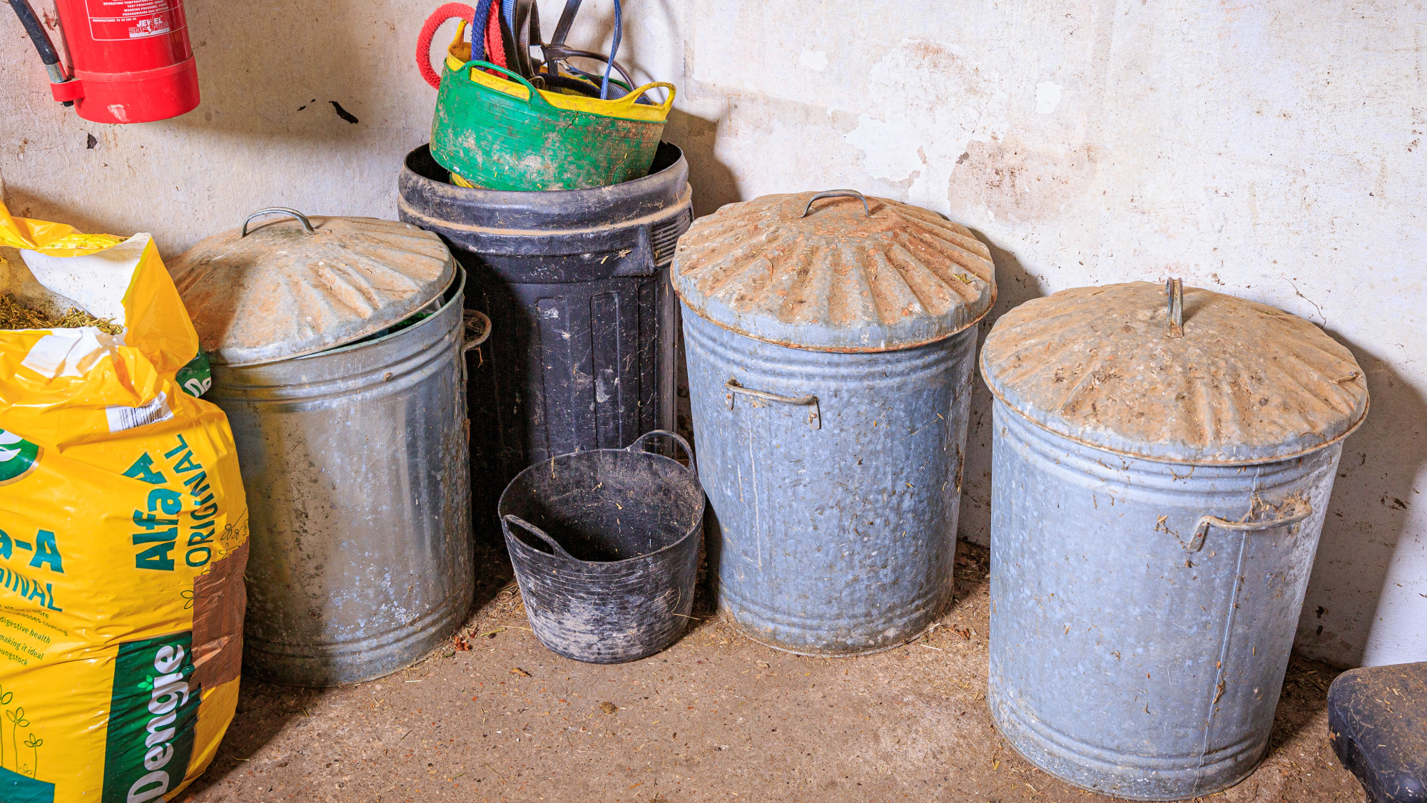 Feed room, with metal feed bins and a bag of chaff