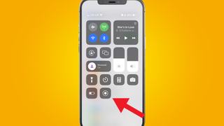 Image showing an iPhone on a yellow background with the command center open and a red arrow pointing to the screen recording button