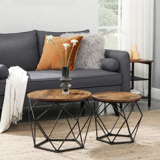two industrial coffee tables in a living room on a sisal rug