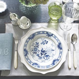 dining table with white dishes and glasses