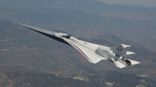 an elongated white jet files above the desert