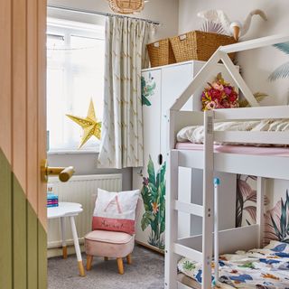 Child's bedroom with white bunk beds and white wardrobe with tropical print pattern