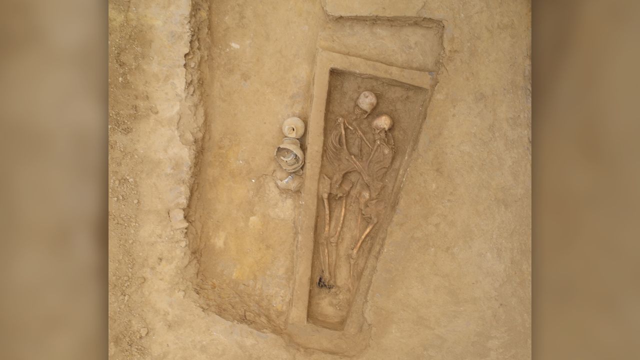 An aerial view of the lovers' burial. Archaeologists found three pottery containers next to the burial and charcoal and ash at the man's foot, "laid as moisture-proof material under the coffin during burial," the researchers wrote in the study.