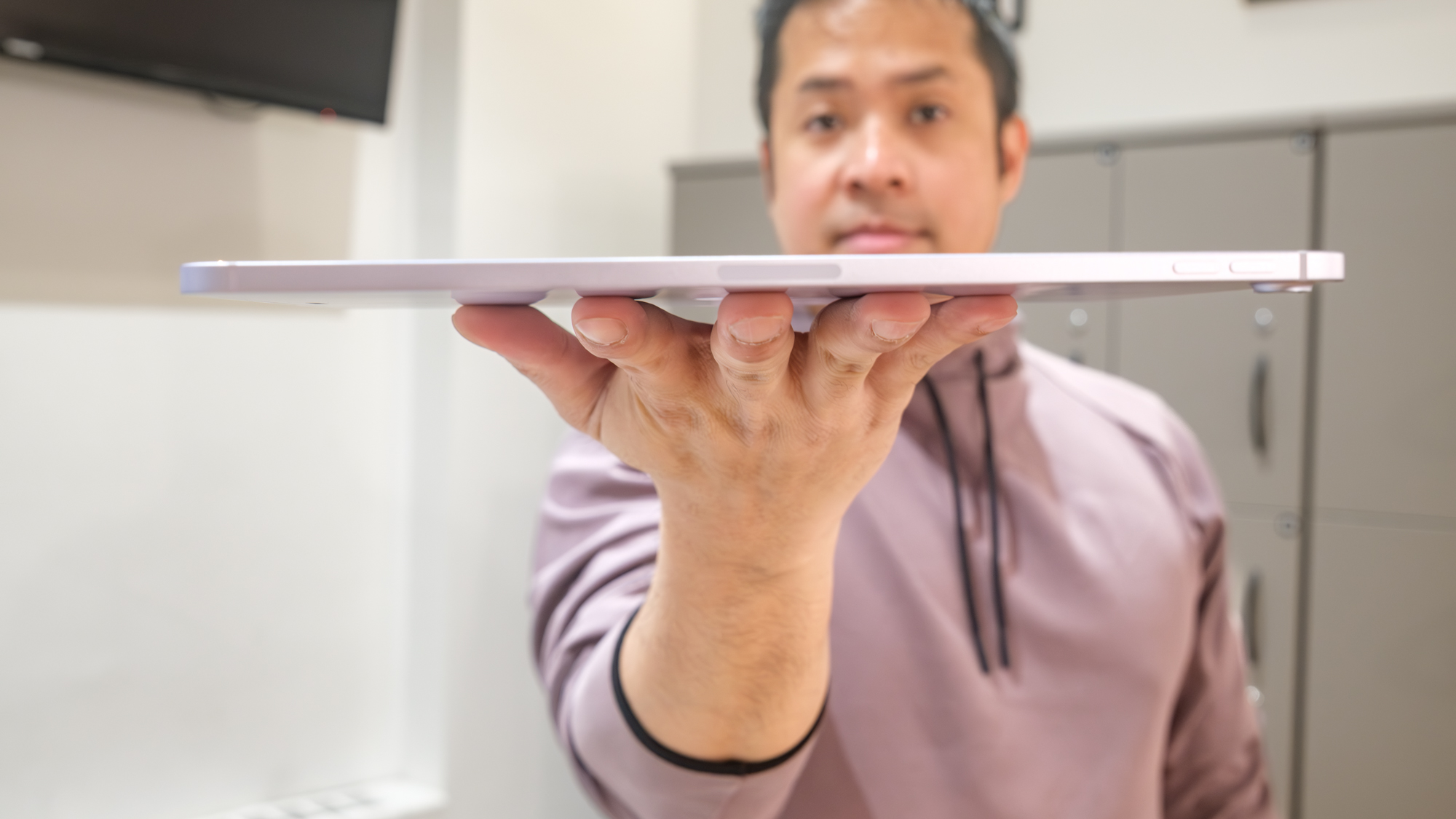 iPad Air M4 being held to show its thinness