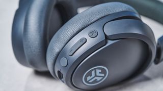 a pair of graphite gray headphones by JLab with 3 buttons