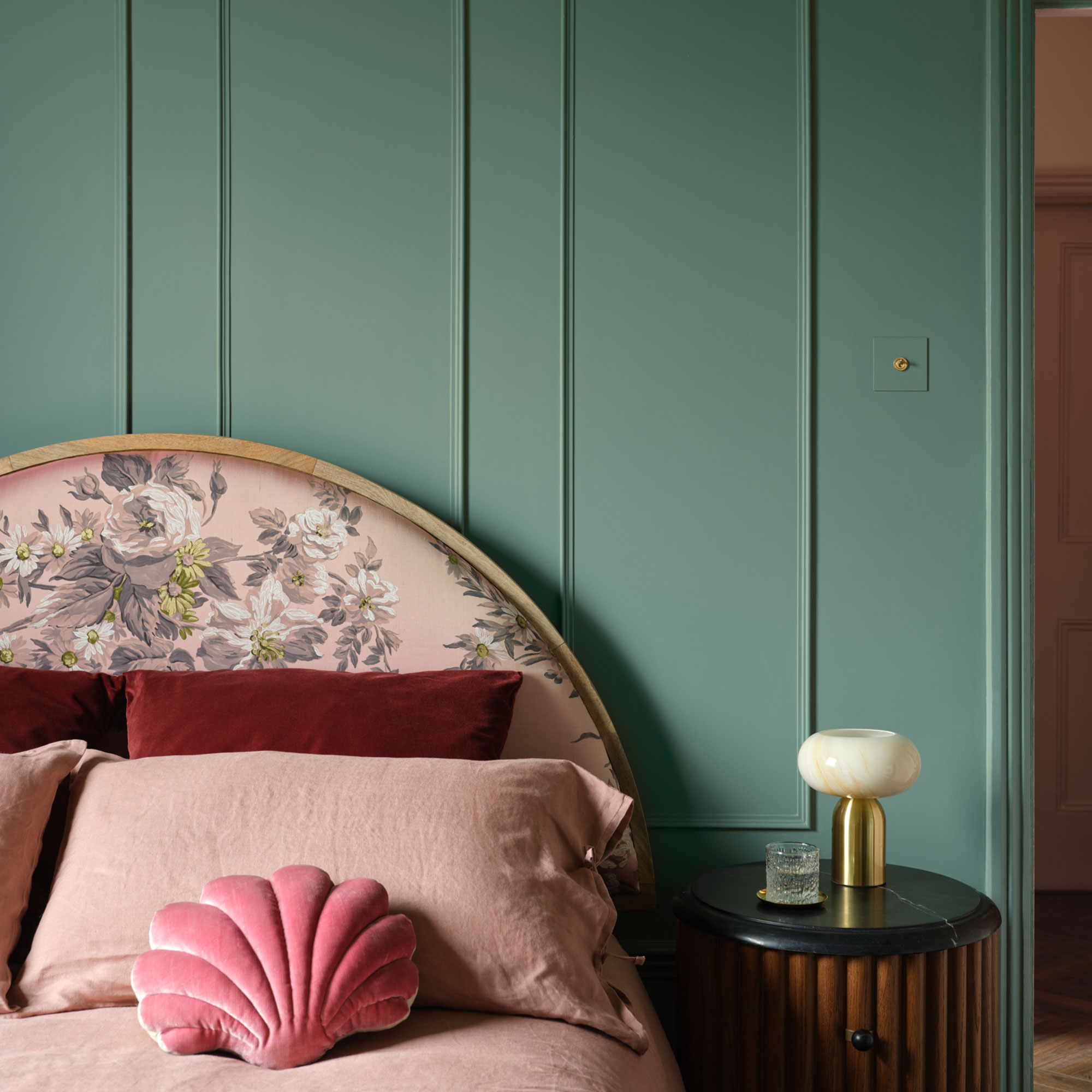 Panelled bedroom wall painted green