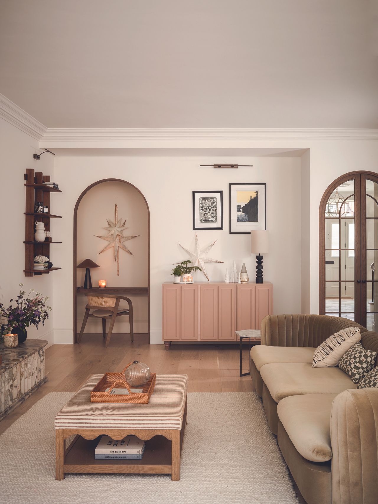 The neutral living room with a pink accent sideboard and Christmas decorations